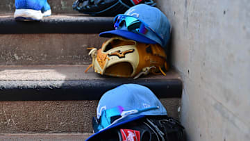 Mar 12, 2024; Salt River Pima-Maricopa, Arizona, USA;  General view of Kansas City Royals hats and gloves in the first inning against the Colorado Rockies during a spring training game at Salt River Fields at Talking Stick. Mandatory Credit: Matt Kartozian-Imagn Images