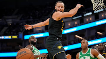 Warriors guard Stephen Curry has the ball knocked out of his hands against the Celtics.