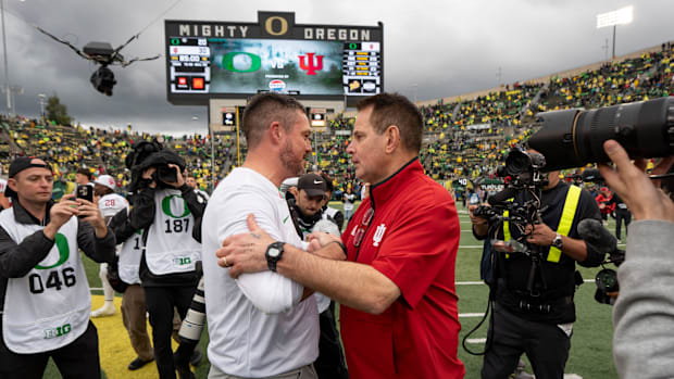 Oregon head coach Dan Lanning, left, shakes hands with Indiana head coach Curt Cignetti as the Oregon Ducks host the Indiana 