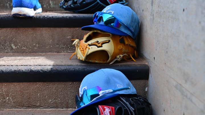 Mar 12, 2024; Salt River Pima-Maricopa, Arizona, USA;  General view of Kansas City Royals hats and gloves in the first inning against the Colorado Rockies during a spring training game at Salt River Fields at Talking Stick. Mandatory Credit: Matt Kartozian-USA TODAY Sports