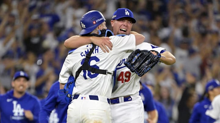 Los Angeles Dodgers pitcher Blake Treinen (49) celebrates with catcher Will Smith.