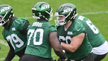 New York Jets offensive tackle Armand Membou participates in a drill with guard Kohl Levao during minicamp