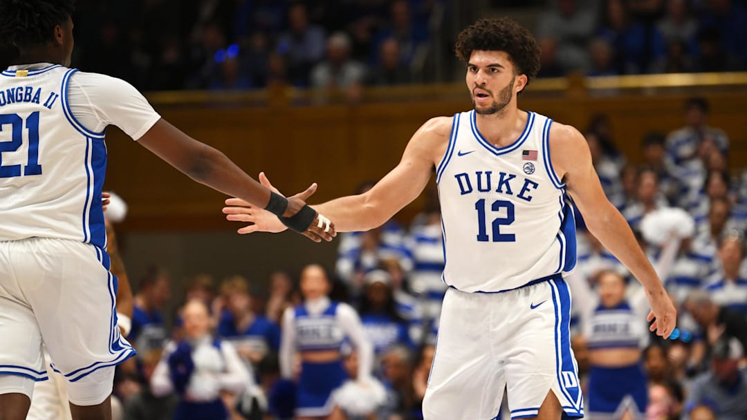Feb 16, 2026; Durham, North Carolina, USA;  Duke Blue Devils forward Cameron Boozer (12) celebrates with Duke Blue Devils center Patrick Ngongba II (21) during the during the second half against the Syracuse Orange at Cameron Indoor Stadium. Mandatory Credit: Zachary Taft-Imagn Images