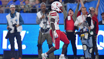 Nov 8, 2025; Pasadena, California, USA; Nebraska Cornhuskers running back Emmett Johnson (21) scores a touchdown against the UCLA Bruins during the second half at the Rose Bowl.
