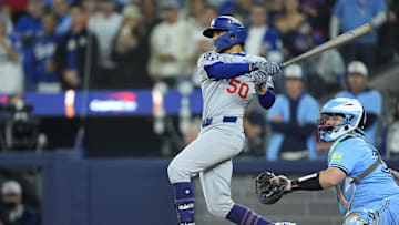 Oct 31, 2025; Toronto, Ontario, CAN; Los Angeles Dodgers shortstop Mookie Betts (50) hits a two RBI single against the Toronto Blue Jays in the third inning during game six of the 2025 MLB World Series at Rogers Centre. Mandatory Credit: John E. Sokolowski-Imagn Images