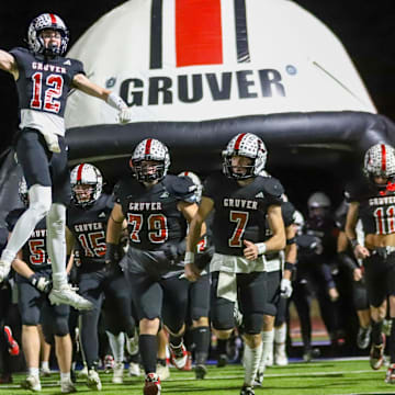 The Gruver football team heads out of the tunnel to face Muenster in a Class 2A Division II state semifinal game Thursday, Dec. 12, 2024 at Fair Park Stadium in Childress, Texas.