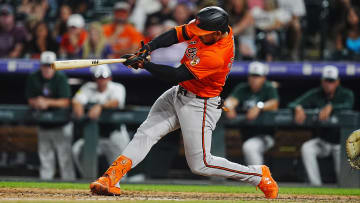 Aug 31, 2024; Denver, Colorado, USA; Baltimore Orioles outfielder Anthony Santander (25) hits a double in the eighth inning against the Colorado Rockies at Coors Field. 