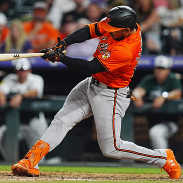 Aug 31, 2024; Denver, Colorado, USA; Baltimore Orioles outfielder Anthony Santander (25) hits a double in the eighth inning against the Colorado Rockies at Coors Field. 