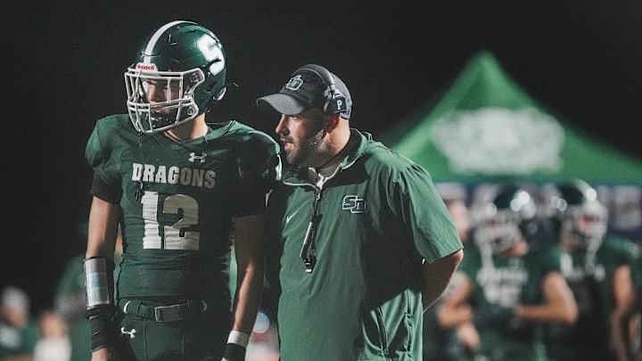 South Oldham head coach Cain Sams talks with South Oldham's Adrian Miles (12) in the Dragons' win over North Oldham Friday Sept. 13, 2024 at Mitchell Irvin Stadium in KHSAA football at Crestwood, Kentucky.