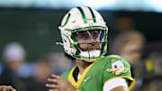 Oregon Ducks quarterback Dante Moore warms up before a game against the Minnesota Golden Gophers at Autzen Stadium.