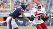 Oct 12, 2024; Charlottesville, Virginia, USA; Louisville Cardinals running back Isaac Brown (25) carries the ball past Virginia Cavaliers safety Corey Thomas Jr. (3) to score a touchdown during the second half at Scott Stadium. Mandatory Credit: Amber Searls-Imagn Images