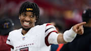 Sep 29, 2024; Glendale, Arizona, USA; Washington Commanders quarterback Jayden Daniels (5) celebrates in the closing seconds of the game against the Arizona Cardinals at State Farm Stadium. Mandatory Credit: Mark J. Rebilas-Imagn Images