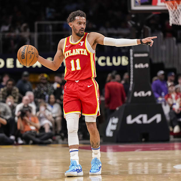 Atlanta Hawks guard Trae Young (11) points to a teammate against the Charlotte Hornets during the 2023-24 season.