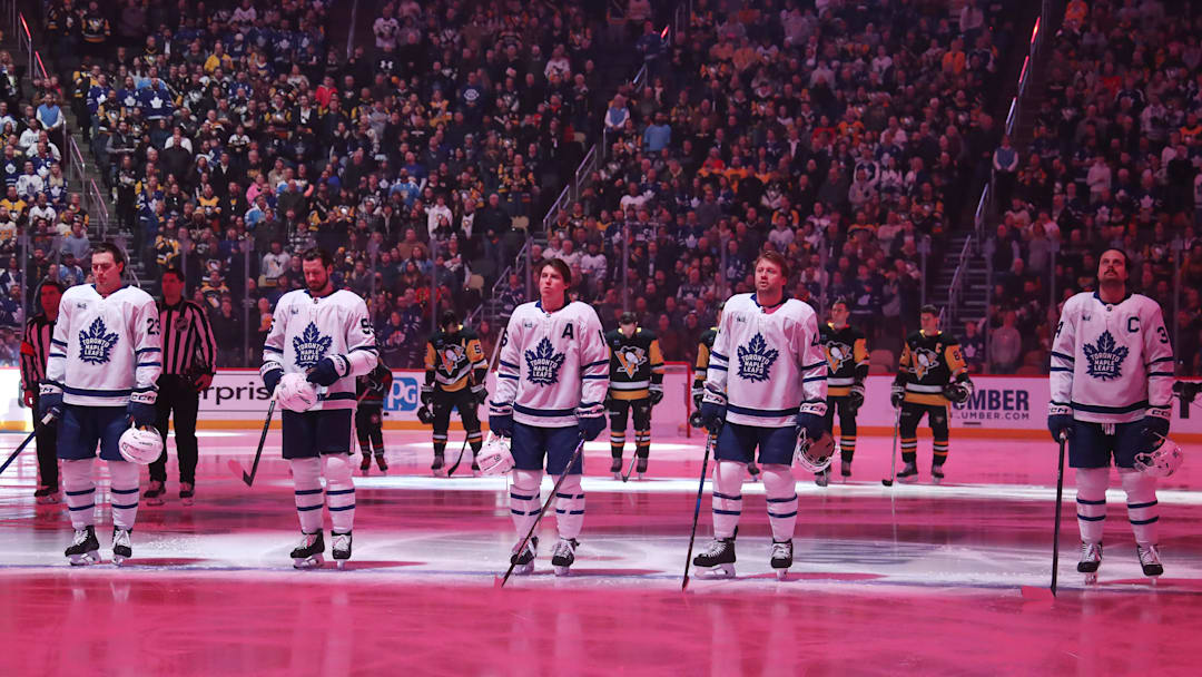 Mar 2, 2025; Pittsburgh, Pennsylvania, USA;  Toronto Maple Leafs starting line-up of (L to R) left wing Matthew Knies (23) and defenseman Oliver Ekman-Larsson (95) and right wing Mitch Marner (16) and defenseman Morgan Rielly (44) and center Auston Matthews (34) stand for the national anthem against the Pittsburgh Penguins at PPG Paints Arena. Mandatory Credit: Charles LeClaire-Imagn Images