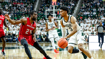 Michigan State's Jaden Akins, right, moves the ball as Rutgers' Austin Williams defends during the first half on Sunday, Jan. 14, 2024, at the Breslin Center in East Lansing.