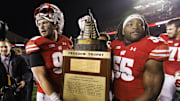 Nov 18, 2023; Madison, Wisconsin, USA;  The Wisconsin Badgers celebrate with the Freedom Trophy following the game against the Nebraska Cornhuskers at Camp Randall Stadium. Mandatory Credit: Jeff Hanisch-Imagn Images