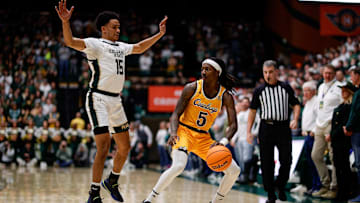 Feb 15, 2025; Fort Collins, Colorado, USA; Wyoming Cowboys guard Obi Agbim (5) controls the ball as Colorado State Rams guard Jalen Lake (15) guards in the first half at Moby Arena. Mandatory Credit: Isaiah J. Downing-Imagn Images