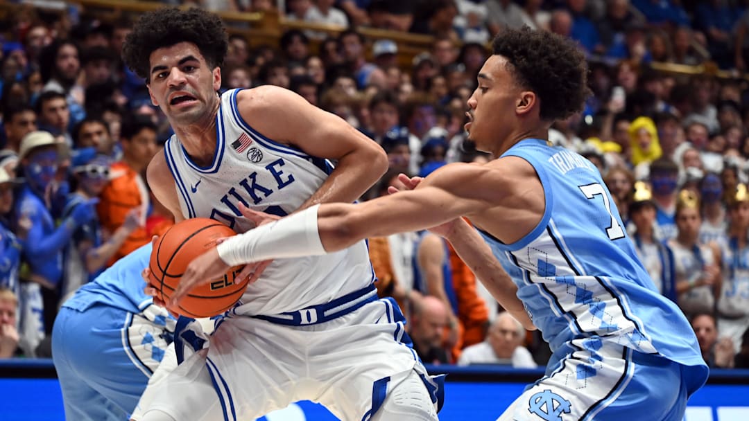 Mar 7, 2026; Durham, North Carolina, USA;Duke Blue Devils guard Cayden Boozer (2) drives to the basket as North Carolina Tar Heels guard Seth Trimble (7) defends during the second half at Cameron Indoor Stadium.  The Duke Blue Devils won 76-61. Mandatory Credit: Rob Kinnan-Imagn Images