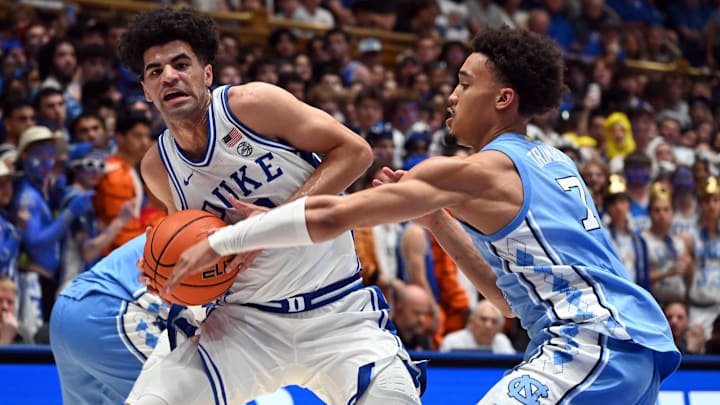 Mar 7, 2026; Durham, North Carolina, USA;Duke Blue Devils guard Cayden Boozer (2) drives to the basket as North Carolina Tar Heels guard Seth Trimble (7) defends during the second half at Cameron Indoor Stadium.  The Duke Blue Devils won 76-61. Mandatory Credit: Rob Kinnan-Imagn Images