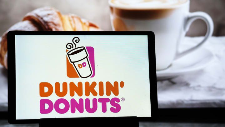 In this photo illustration, a Dunkin Donuts (Dunkin Brands...