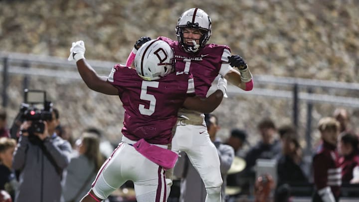 West Des Moines Dowling's Ian Middleton (5) and Jakob Skau (1) celebrate earlier this year vs. Southeast Polk. 