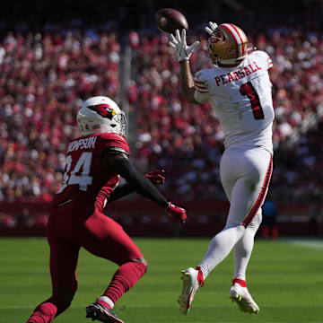 Sep 21, 2025; Santa Clara, California, USA; San Francisco 49ers wide receiver Ricky Pearsall (1) makes the catch inform of Arizona Cardinals safety Jalen Thompson (34) during the second half at Levi's Stadium. Mandatory Credit: Cary Edmondson-Imagn Images