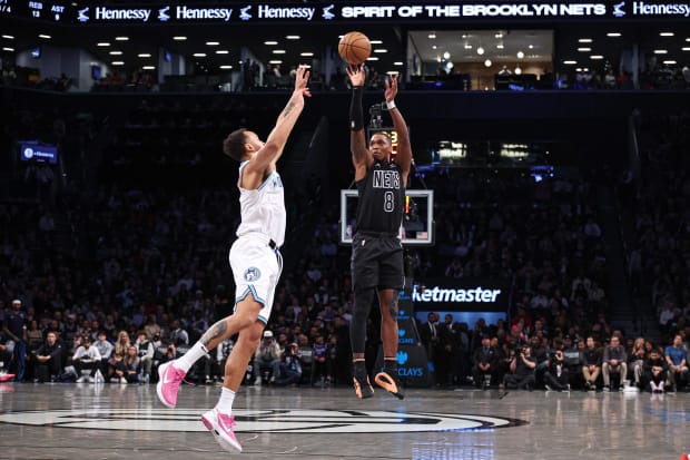 Brooklyn Nets guard Lonnie Walker IV (8) shoots the ball as Minnesota Timberwolves forward Kyle Anderson (1) contests.