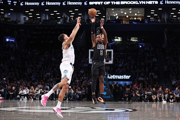 Brooklyn Nets guard Lonnie Walker IV (8) shoots the ball as Minnesota Timberwolves forward Kyle Anderson (1) guards him.