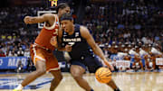 Xavier Musketeers guard Ryan Conwell dribbles the ball defended by Texas Longhorns guard Tramon Mark