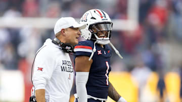 Nov 22, 2025; Tucson, Arizona, USA; Arizona Wildcats defensive coordinator Danny Gonzales with quarterback Noah Fifita (1) against the Baylor Bears at Casino Del Sol Stadium. Mandatory Credit: Mark J. Rebilas-Imagn Images