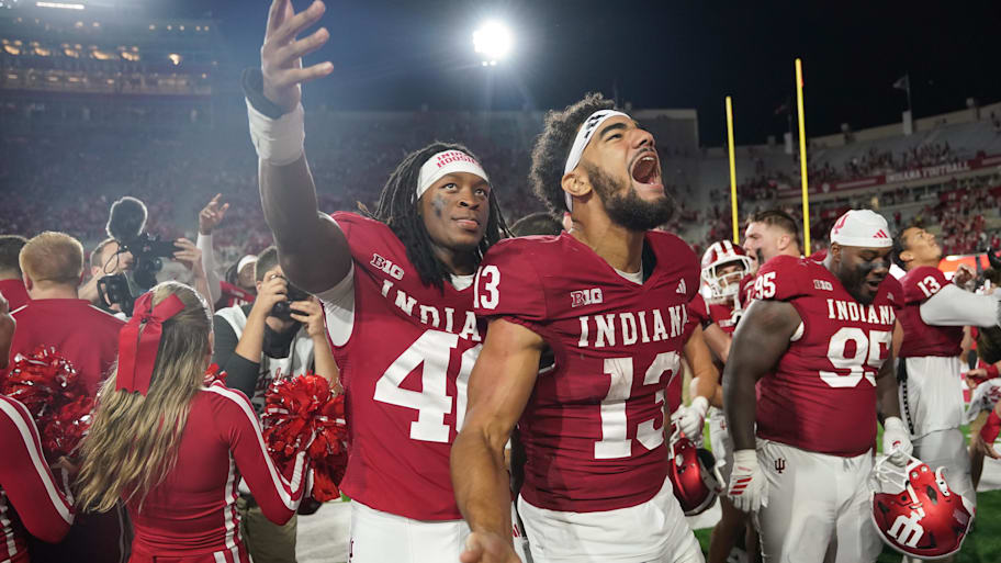 Linebacker Quentin Clark and wide receiver Elijah Sarratt celebrate after defeating Illinois.