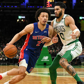 Feb 16, 2022; Boston, Massachusetts, USA; Detroit Pistons guard Cade Cunningham (2) drives to the basket against Boston Celtics forward Jayson Tatum (0) during the first half at the TD Garden. Mandatory Credit: Brian Fluharty-Imagn Images