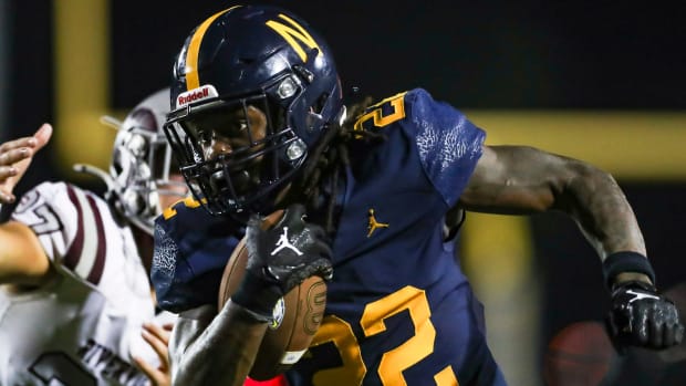 Naples running back Trayvon Jean (22) runs the ball during the third quarter of the season opener against the Riverview.