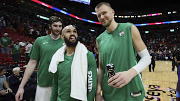 Jan 25, 2024; Miami, Florida, USA; Boston Celtics center Kristaps Porzingis (right), guard Derrick White (center) and center Luke Kornet (left) look on after the game against the Miami Heat at Kaseya Center. Mandatory Credit: Sam Navarro-Imagn Images