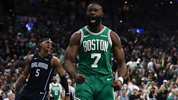 Boston Celtics guard Jaylen Brown (7) shouts out after dunking as Orlando Magic forward Paolo Banchero (5) turns away during the second half of game two of the first round of the 2024 NBA Playoffs at TD Garden.