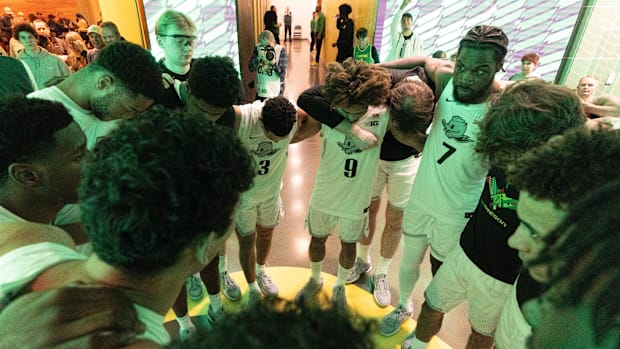 Oregon players gather together off court before their game against Nebraska at Matthew Knight Arena Feb. 2, 2025.