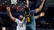 Jan 13, 2025; South Bend, Indiana, USA; Boston College Eagles forward Chad Venning (32)  goes up for a shot as Notre Dame Fighting Irish forward Kebba Njie (14) defends in the first half at the Purcell Pavilion. Mandatory Credit: Matt Cashore-Imagn Images