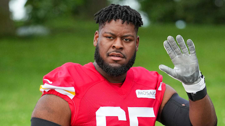 Jul 22, 2025; St. Joseph, MO, USA; Kansas City Chiefs guard Trey Smith (65) waves to fans while walking down the hill to the fields during training camp at Missouri Western State University. Mandatory Credit: Denny Medley-Imagn Images