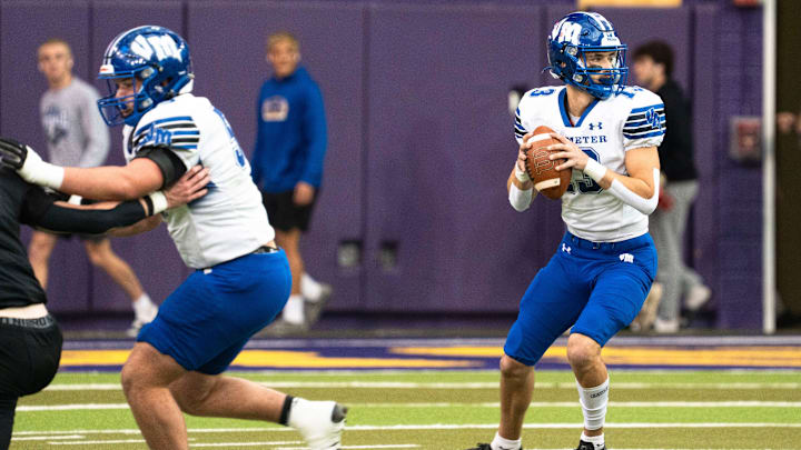 Van Meter's Henry Lounsbury looks to attempt a pass during the semifinal round of the Iowa high school football state championships at the UNI-Dome on Saturday, Nov. 15, 2025, in Cedar Falls.