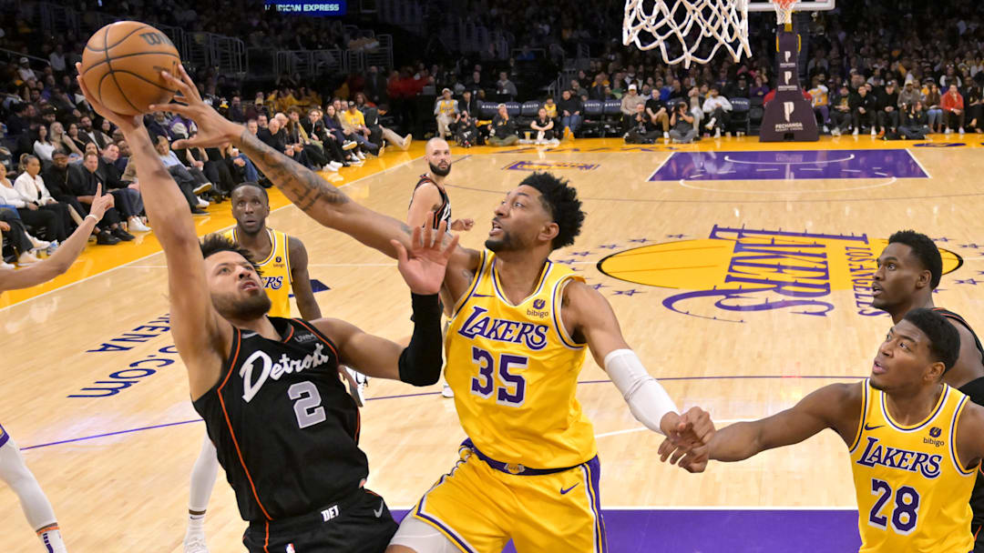 Feb 13, 2024; Los Angeles, California, USA;  Los Angeles Lakers forward Christian Wood (35) blocks a shot by Detroit Pistons guard Cade Cunningham (2) in the second half at Crypto.com Arena. Mandatory Credit: Jayne Kamin-Oncea-Imagn Images