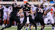 Sep 19, 2025; Stillwater, Oklahoma, USA; Oklahoma State Cowboys quarterback Zane Flores (6) behind the line during the second half against the Tulsa Golden Hurricane at Boone Pickens Stadium. Mandatory Credit: William Purnell-Imagn Images