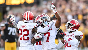 Sep 27, 2025; Iowa City, Iowa, USA; Indiana Hoosiers defensive back Louis Moore (7) reacts with defensive back Jamari Sharpe (22) and defensive back Ryland Gandy (10) after making an interception during the fourth quarter against the Iowa Hawkeyes at Kinnick Stadium. Mandatory Credit: Jeffrey Becker-Imagn Images