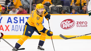 Jan 18, 2025; Nashville, Tennessee, USA;  Nashville Predators left wing Filip Forsberg (9) skates with the puck against the Minnesota Wild during the third period at Bridgestone Arena. Mandatory Credit: Steve Roberts-Imagn Images