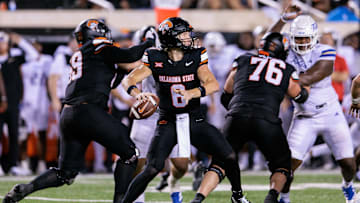Sep 19, 2025; Stillwater, Oklahoma, USA; Oklahoma State Cowboys quarterback Zane Flores (6) behind the line during the second half against the Tulsa Golden Hurricane at Boone Pickens Stadium. Mandatory Credit: William Purnell-Imagn Images