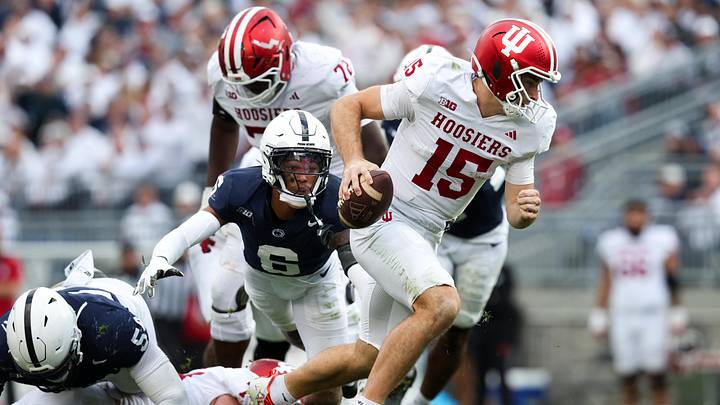 Nov 8, 2025; University Park, Pennsylvania, USA; Indiana Hoosiers quarterback Fernando Mendoza (15) runs with the ball while being pressured by Penn State Nittany Lions safety Zakee Wheatley (6) during the third quarter at Beaver Stadium. Mandatory Credit: Matthew O'Haren-Imagn Images