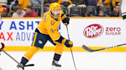 Jan 18, 2025; Nashville, Tennessee, USA;  Nashville Predators left wing Filip Forsberg (9) skates with the puck against the Minnesota Wild during the third period at Bridgestone Arena. Mandatory Credit: Steve Roberts-Imagn Images