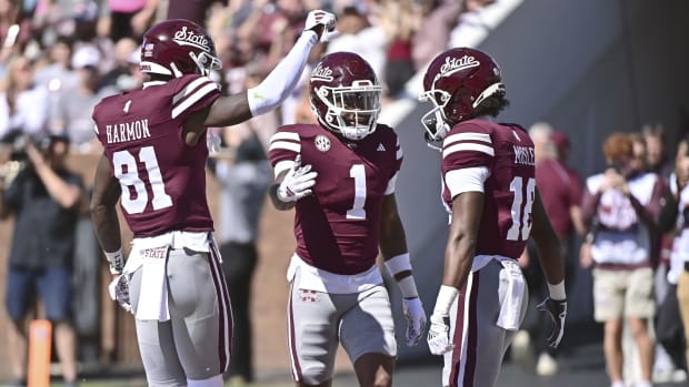 Mississippi State Bulldogs players celebrate a touchdown during a college football game in the SEC.