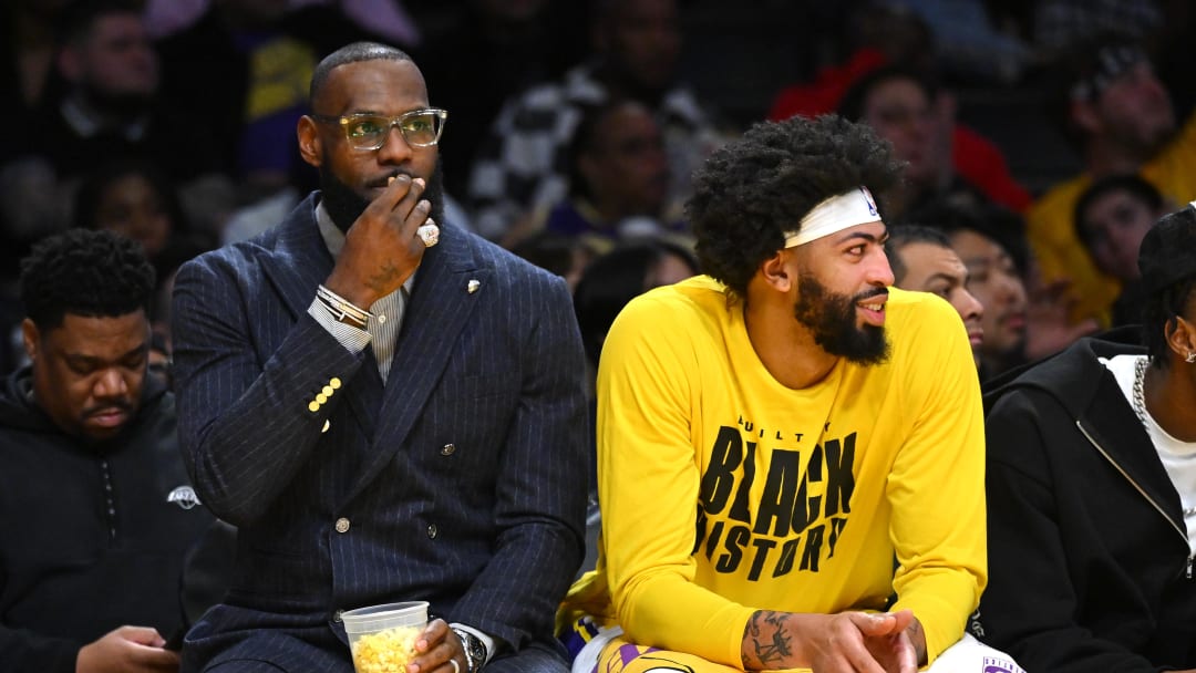 Feb 9, 2023; Los Angeles, California, USA;   Los Angeles Lakers forward LeBron James (6) snacks on popcorn on the bench as he sits next to Los Angeles Lakers forward Anthony Davis (3) in the first half against the Milwaukee Bucks at Crypto.com Arena. Mandatory Credit: Jayne Kamin-Oncea-USA TODAY Sports