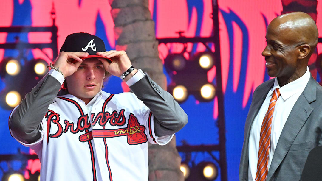 Jul 17, 2022; Los Angeles, CA, USA;  Former Atlanta Braves player Fred McGriff presents JR Ritchie right with his jersey after he was selected by the Atlanta Braves as the 35th pick of the MLB draft at XBox Plaza at LA Live. Mandatory Credit: Jayne Kamin-Oncea-Imagn Images