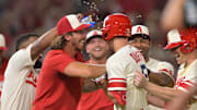 Angels third baseman Matt Duffy (5) celebrates with starting pitcher Michael Lorenzen (25) and left fielder Jo Adell (7) and catcher Max Stassi (33) after hitting a walk off single to score the winning run against the Houston Astros in the 12th inning at Angel Stadium on Sept. 3, 2022.